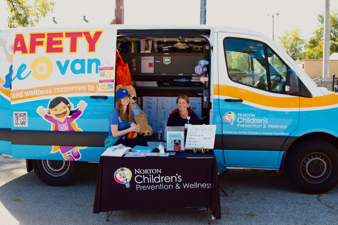 Norton Children's Prevention & Wellness van and table at the Harvest Bazaar Health Fair